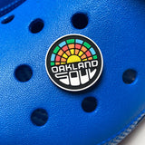 Oakland Soul crest pvc shoe charm model on blue clogs.