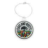 Acrylic Oakland Roots crest ornament with silver string.