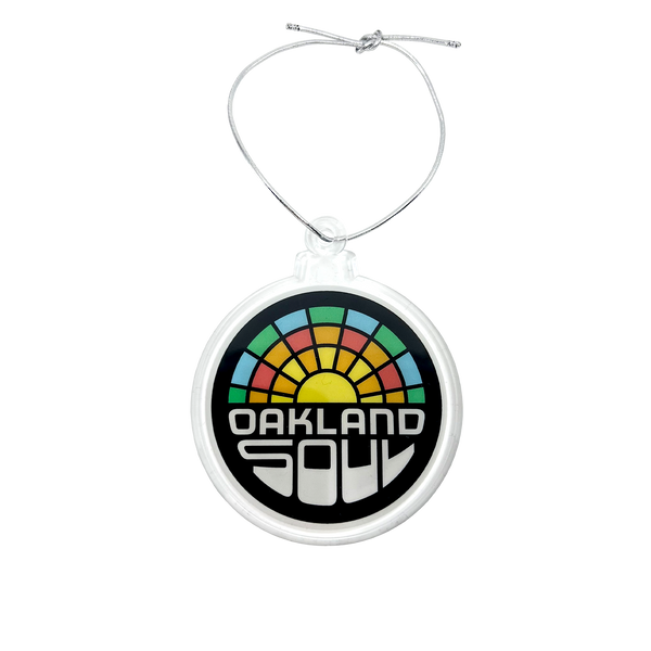 Acrylic Oakland soul crest ornament with silver string.